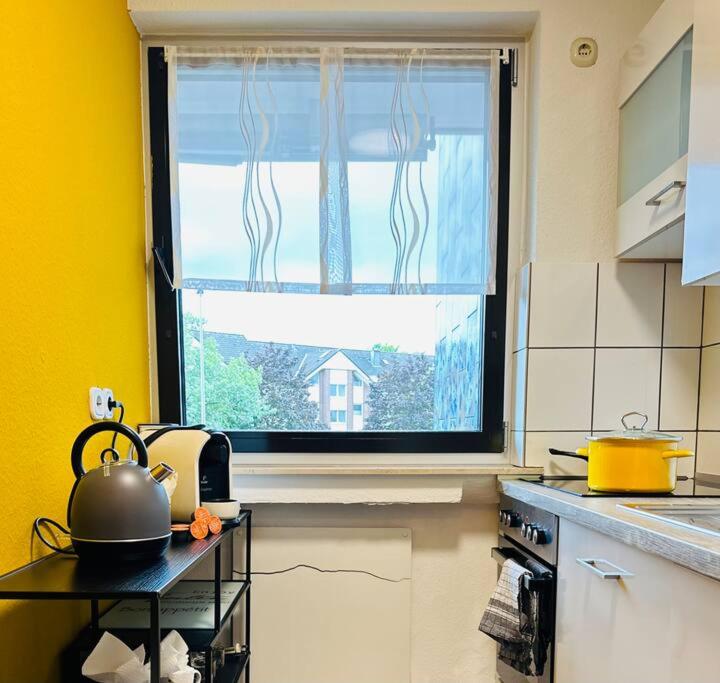 a kitchen with a window and a tea kettle on a table at Centro-ist-nicht-mehr-weit in Oberhausen