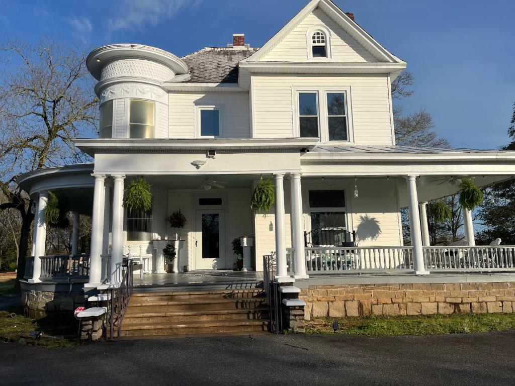 a large white house with a large porch at Enloe House in Roanoke