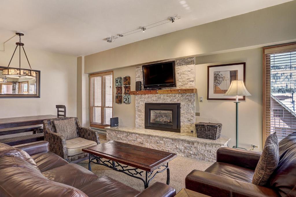 a living room with a couch and a fireplace at Ski In-Out Village at Breckenridge Condo in Breckenridge