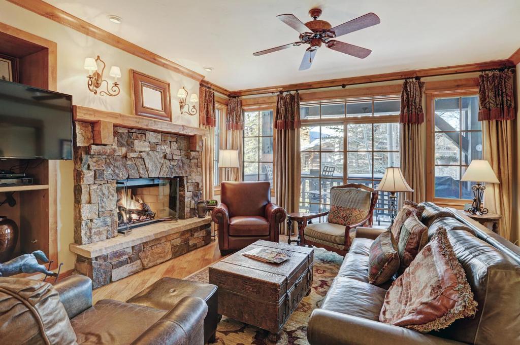 a living room with a couch and a fireplace at Luxurious 2 Bedroom Condo 50 Feet From The Slopes! condo in Beaver Creek