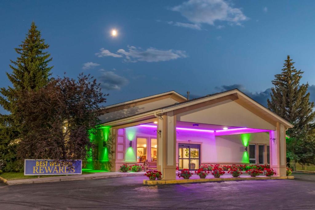 a building with green and purple lights on it at SureStay Plus Hotel by Best Western Buffalo in Buffalo