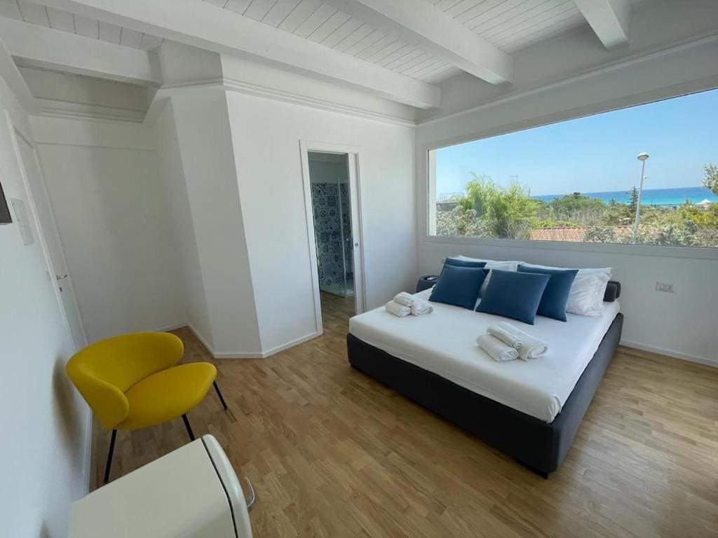 a bedroom with a bed and a large window at ITINERA Baia Verde Rooms and Breakfast in Gallipoli