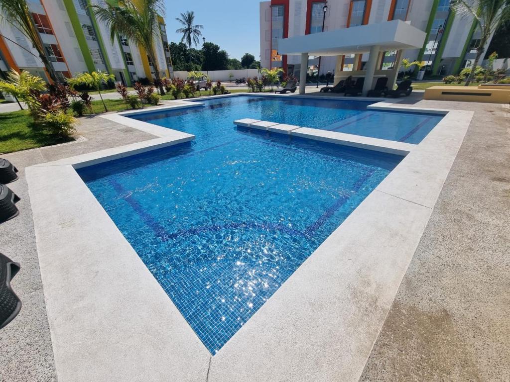 a swimming pool in front of a building at La Morada de Sofía in La Sabana