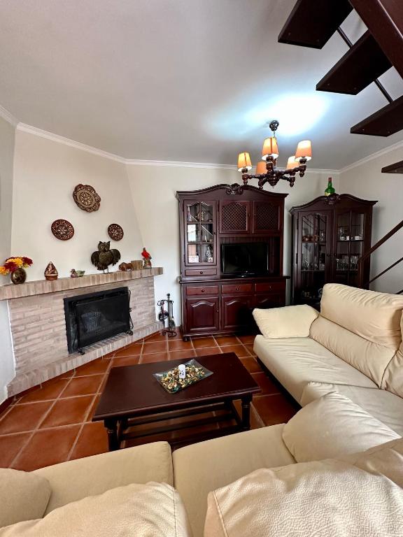 - un salon avec un canapé et une cheminée dans l'établissement Villa Grazalema casa rural con encanto, à Grazalema