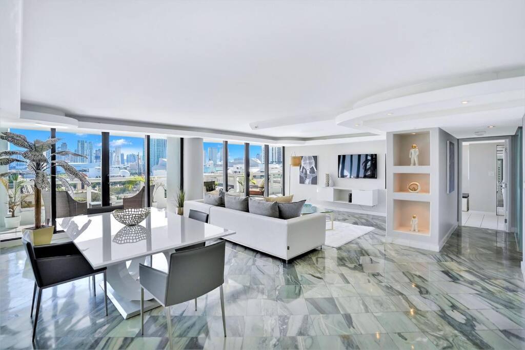 a living room with a white table and a couch at Sea Forever! Miami Skyline And Water Views in Miami