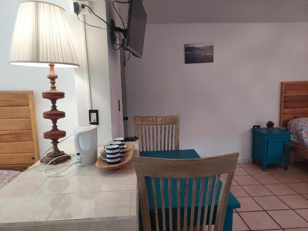 a room with a table and chairs and a bedroom at Casa Nopal Tu casa vacacional tipo hotel in Creel