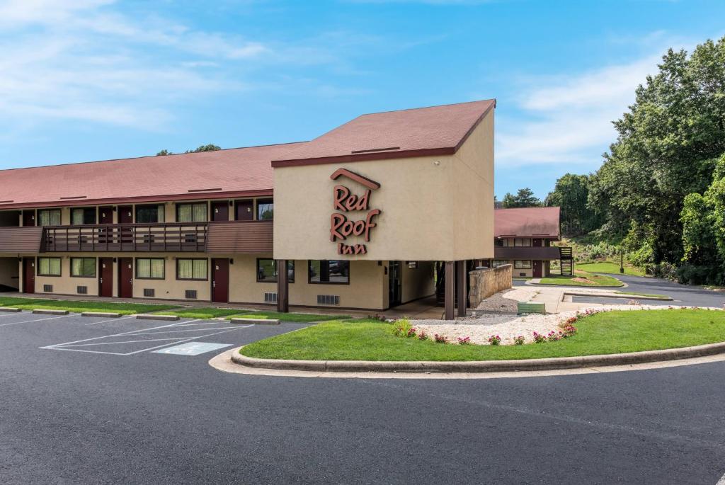 a hotel with a sign on the side of a road at Red Roof Inn Hickory in Hickory
