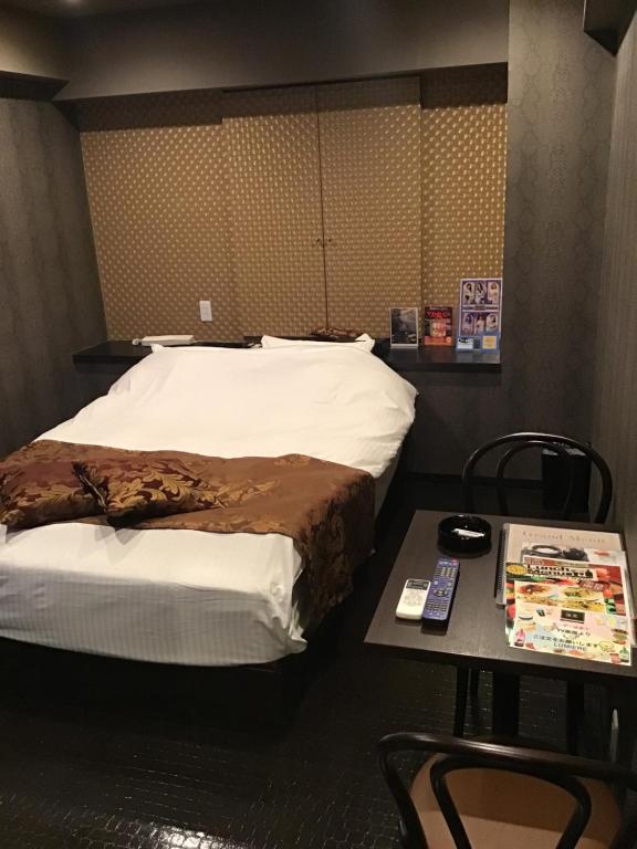 Postel nebo postele na pokoji v ubytování ホテルルミエール
