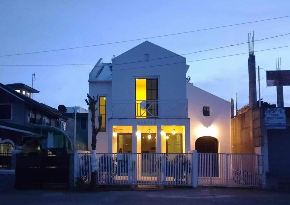 a white house with a fence in front of it at Sa Plaza - Benita in Dolores