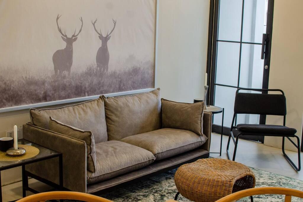 a living room with a couch and a picture of deer at Benita At the Plaza in Dolores