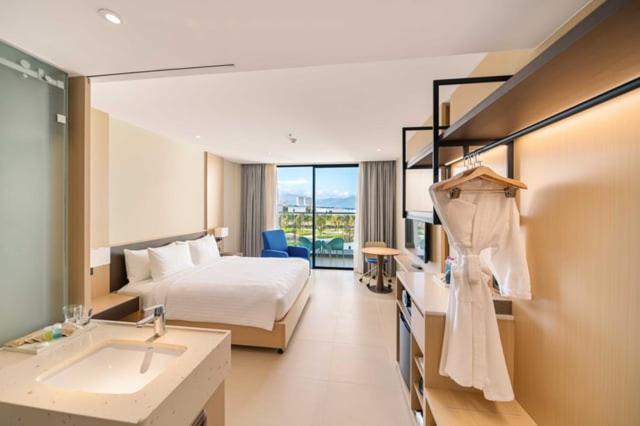 a hotel room with a bed and a sink at Arena in Dien Khanh