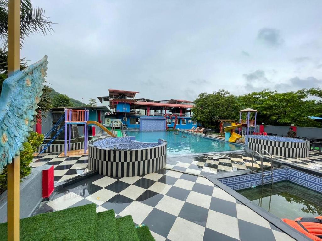 a pool with a checkered floor and a water park at Wayfare SP Resort in Panvel