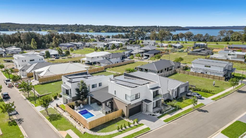 an aerial view of a large white house at Luxurious Lakeside Oasis in Morisset East