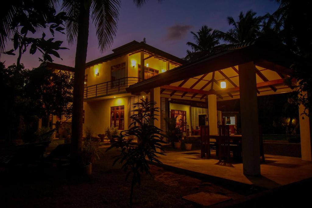 a house at night with the lights on at Villa A.SMS in Induruwa
