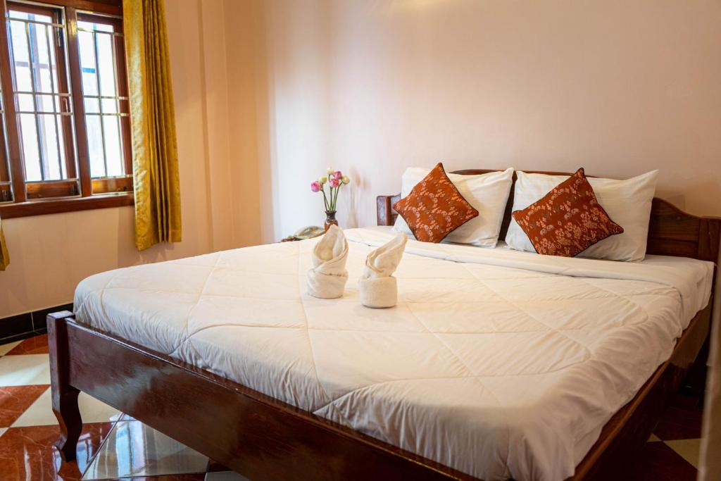 Postel nebo postele na pokoji v ubytování Nawin Palace Guesthouse