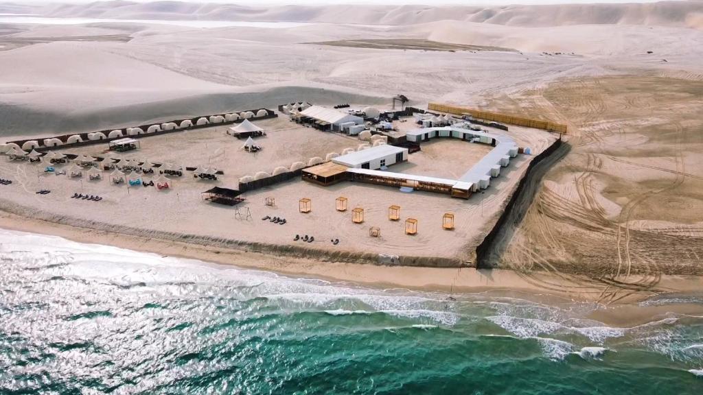 an aerial view of a resort on the beach at Al-Rahal Desert Camp in Mesaieed