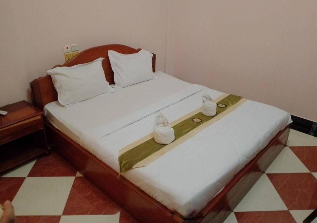Postel nebo postele na pokoji v ubytování Nawin Palace Guesthouse