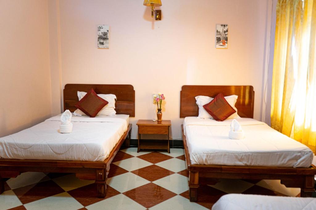 Postel nebo postele na pokoji v ubytování Nawin Palace Guesthouse