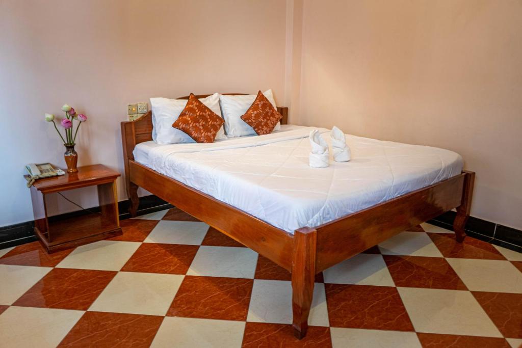 Postel nebo postele na pokoji v ubytování Nawin Palace Guesthouse