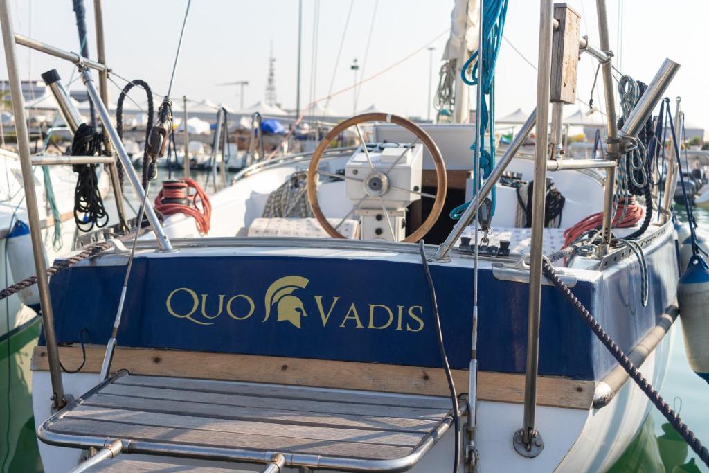 a blue boat with a sign on the side of it at Quo Vadis Yacht in Bari