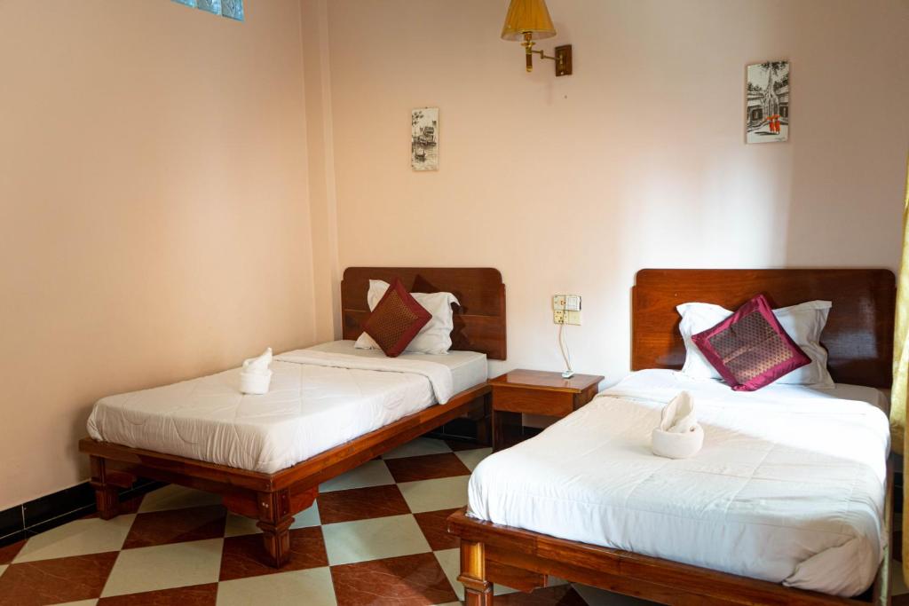 Postel nebo postele na pokoji v ubytování Nawin Palace Guesthouse