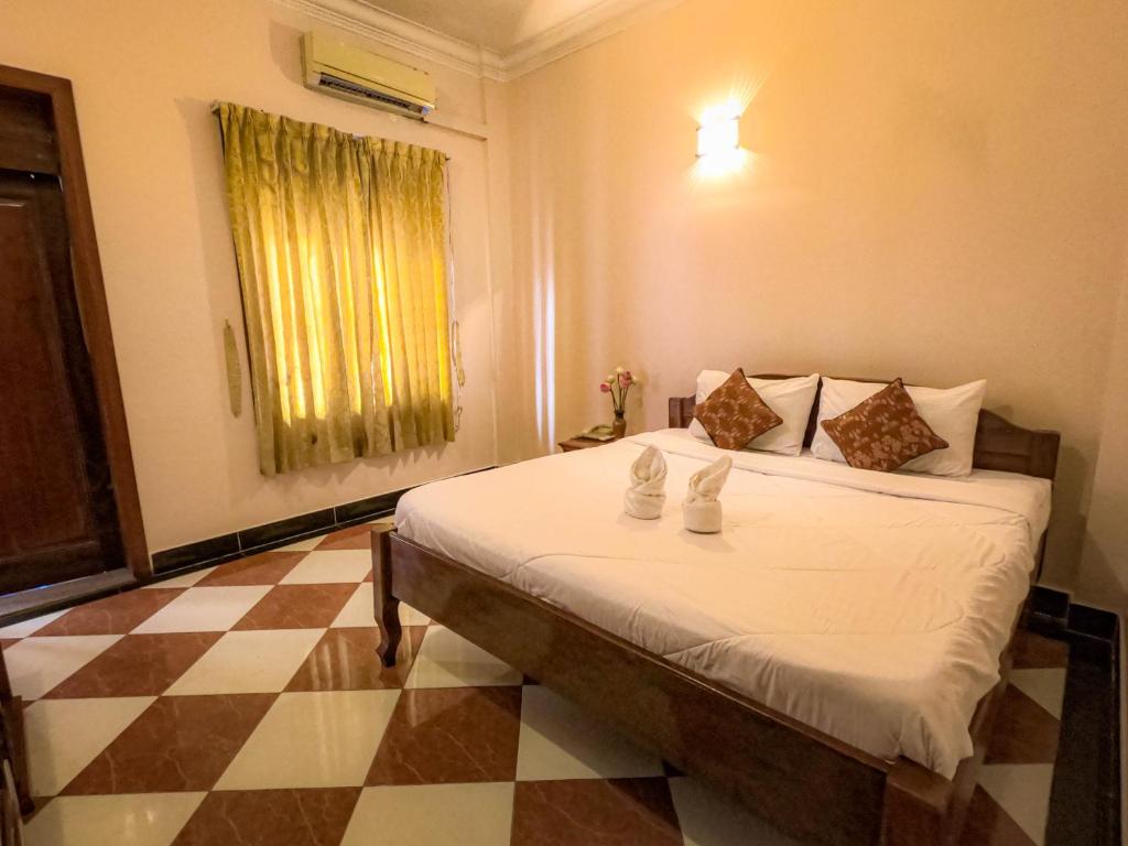 Postel nebo postele na pokoji v ubytování Nawin Palace Guesthouse