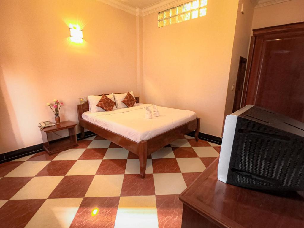 Postel nebo postele na pokoji v ubytování Nawin Palace Guesthouse