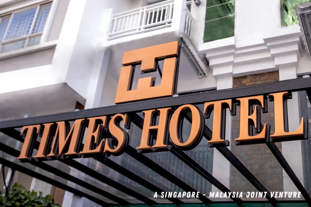 a sign for a times hotel in front of a building at Times Hotel at Bassac Lane in Phnom Penh