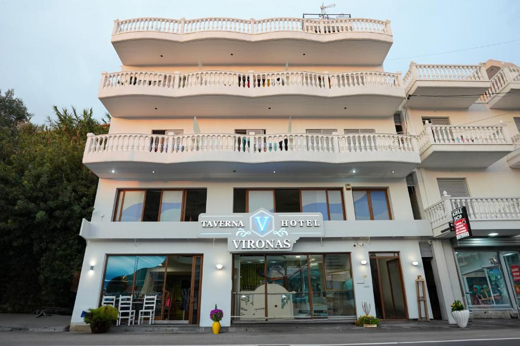 a building with a balcony on top of it at Vironas Hotel in Himare