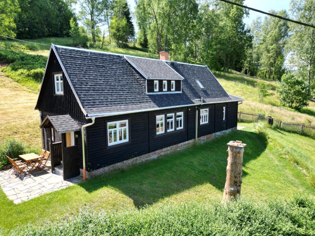 a black house with a black roof at Ferienhaus Anno Dazumal, wie zu Großmutters Zeiten in Klingenthal