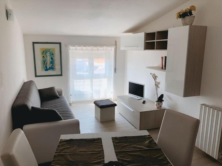 a living room with a couch and a table at Luis Apartment - Appartamento per single o coppia R7265 in Nuoro