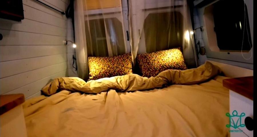 a large bed with leopard pillows in a room at Le confort en nature avec VANTASTIP in Villeneuve-sous-Dammartin