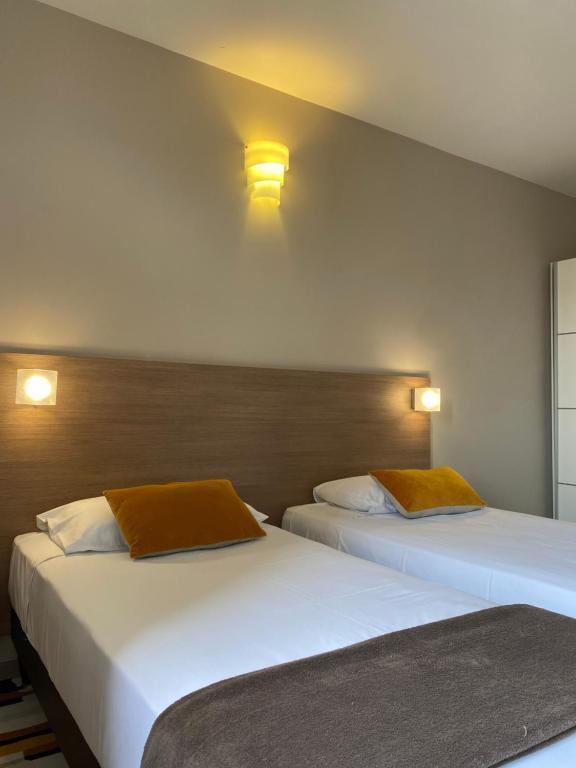 Postel nebo postele na pokoji v ubytování Forme-hotel & Spa Montpellier Sud-Est - Parc Expositions - Arena