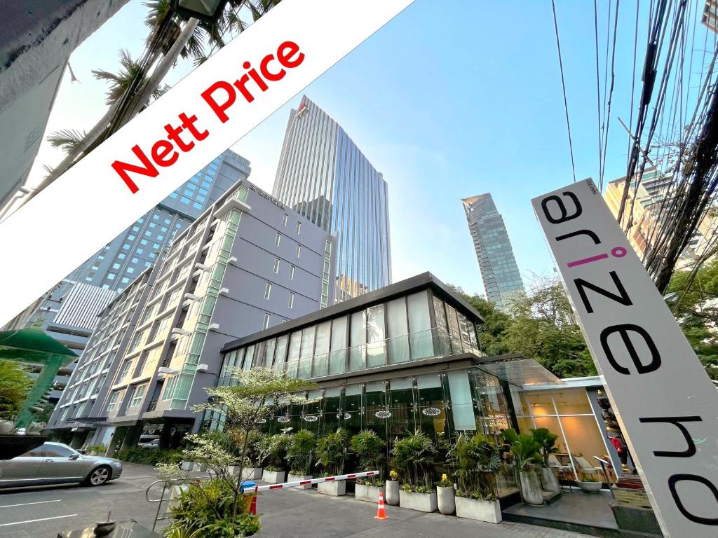 a new price sign in front of a building at Arize Hotel Sukhumvit in Bangkok