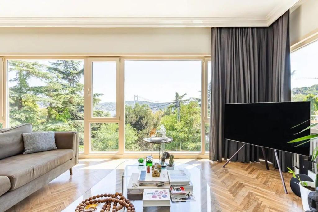 a living room with a couch and a large window at Renovu Premium Flats in Bosphorus in Istanbul