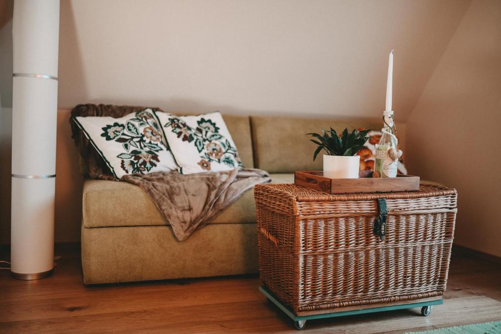 a living room with a couch and a table with a basket at Kultur Weingut Kästenburg in Ratsch an der Weinstraße