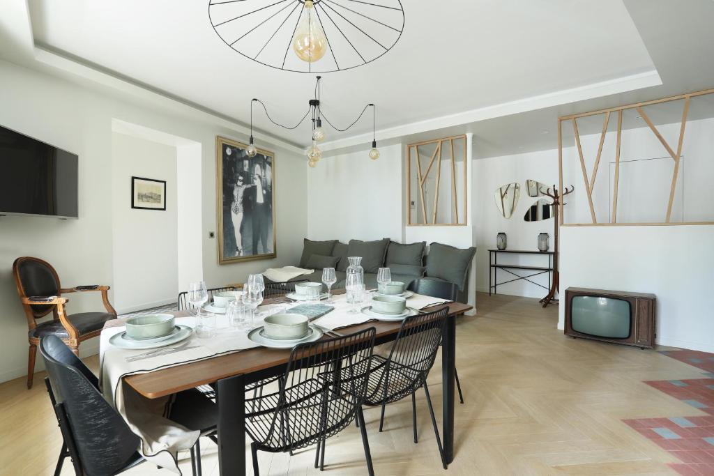 a dining room and living room with a table and chairs at Apartment Saint Germain des Prés by Studio prestige in Paris