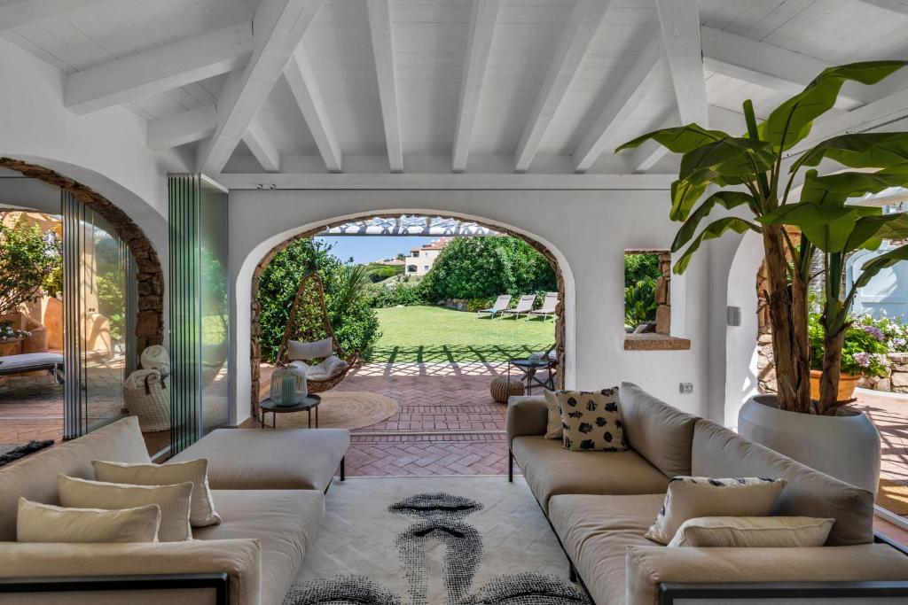 an open living room with couches and a patio at [VILLA SULLA SPIAGGIA]Luxury Vista Mare in Porto Cervo