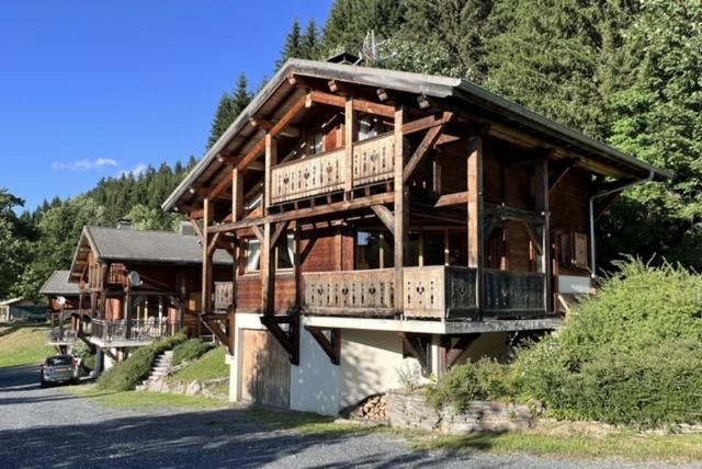 a large wooden house with balconies on the side of it at Chalet Pierre, Les Gets in Les Gets