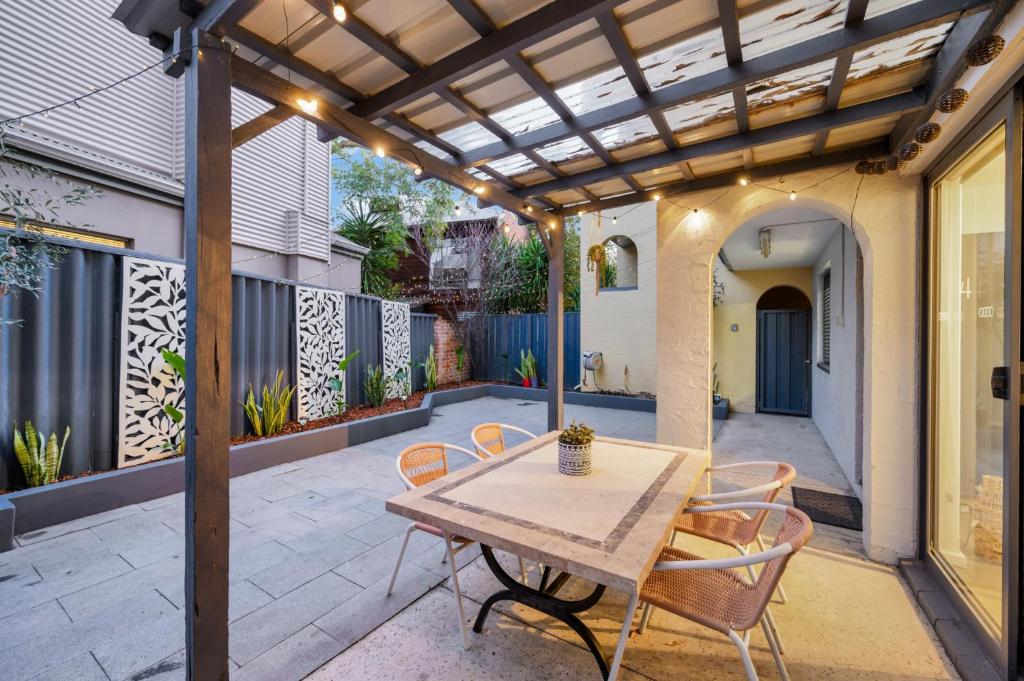 an outdoor patio with a wooden table and chairs at CENT29 - Riverside Retreat in Perth