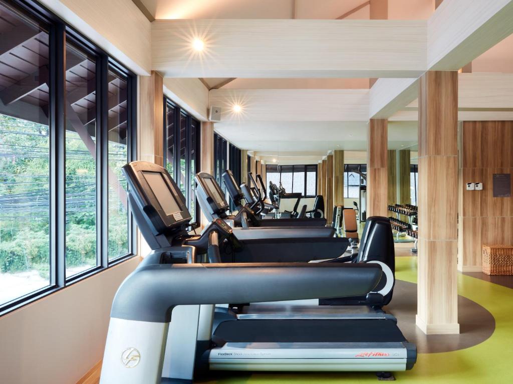 a row of treadmills in a gym with windows at Amari Koh Samui in Chaweng