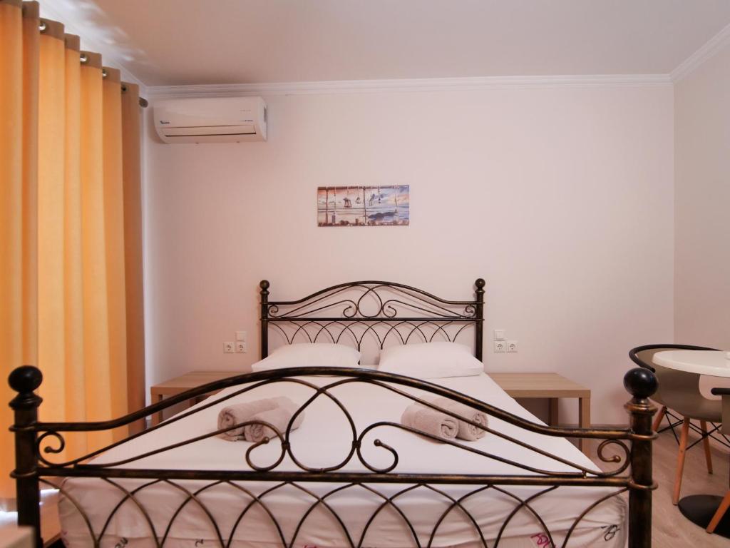 a bedroom with a black bed in a room at Vironas Hotel in Himare