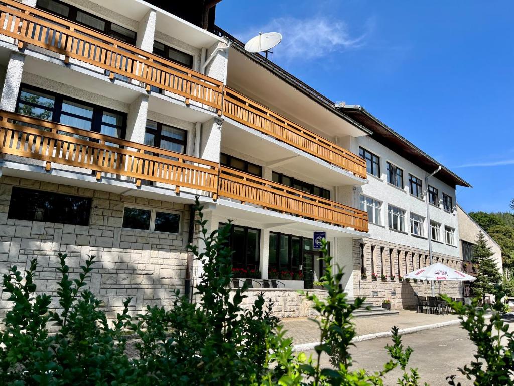 a building with a wooden balcony on top of it at Ośrodek Wypoczynkowy Sudety in Szklarska Poręba