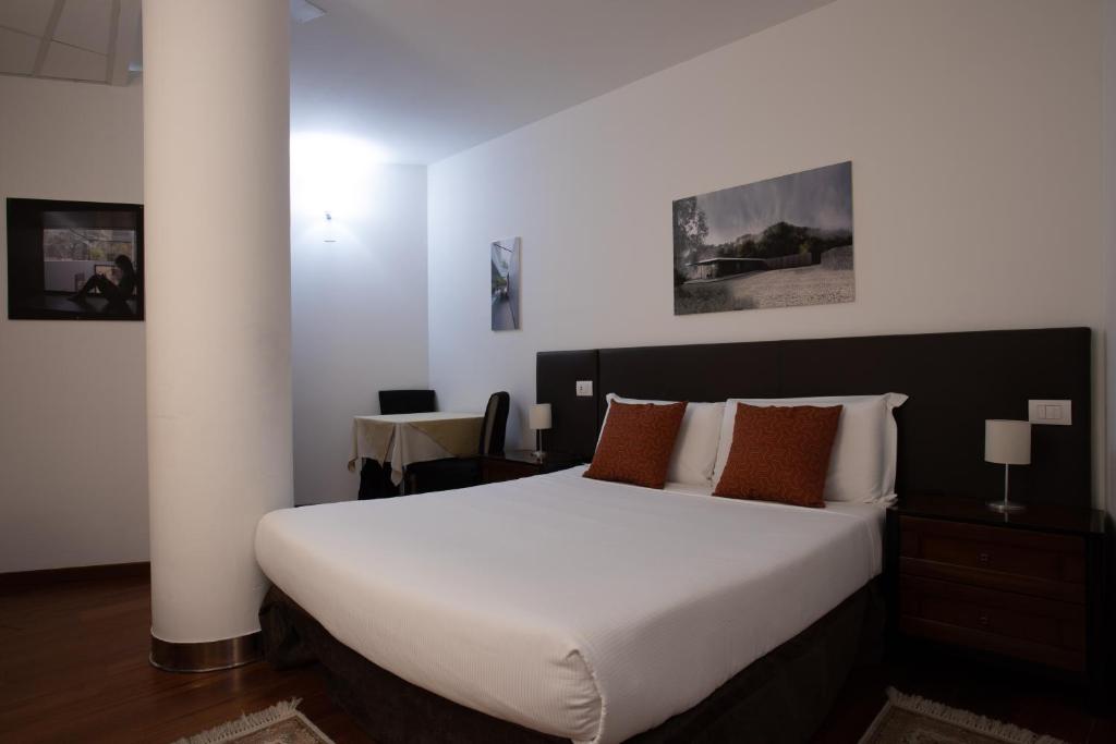 A bed or beds in a room at Ego' Residence Ferrara