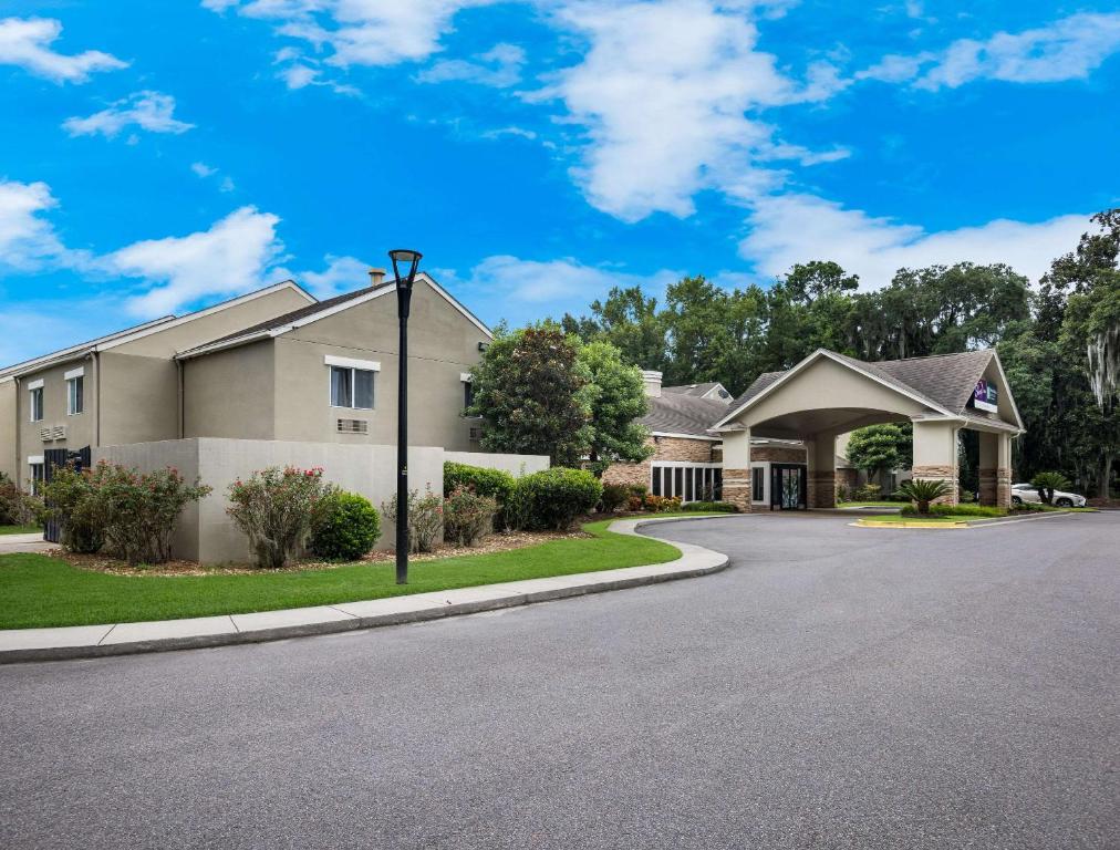 a house on a street with a driveway at MainStay Suites Savannah Midtown in Savannah