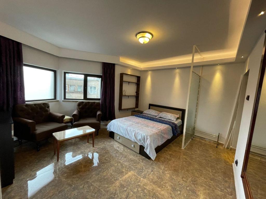 a bedroom with a bed and a couch and a table at Bucharest Old Town Smardan Apartment in Bucharest