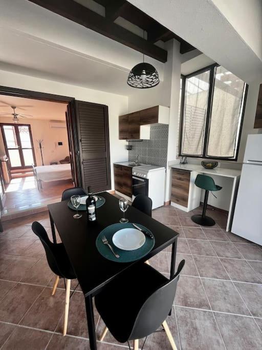 a kitchen with a table and chairs in a room at La Mansarda di Anastasia in Monteroni di Lecce