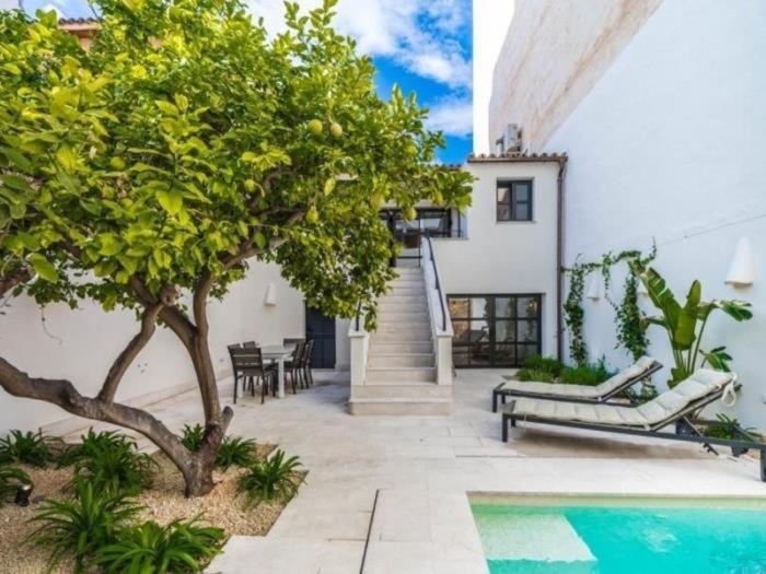 a home with a swimming pool and a house at Can montis in Palma de Mallorca