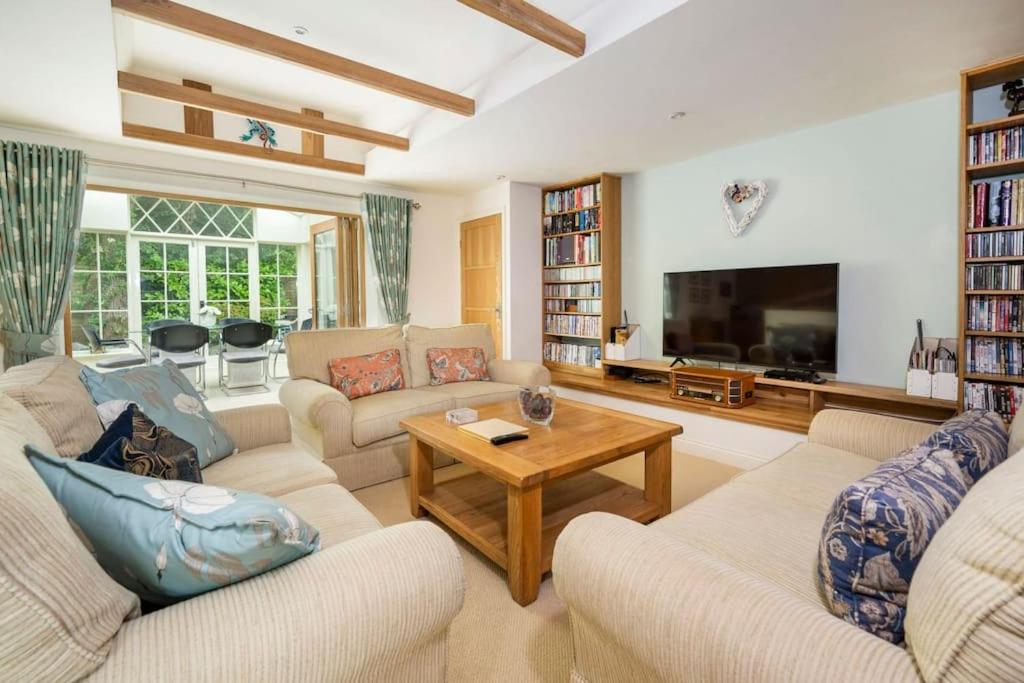 a living room with two couches and a tv at The Granary at Pannels Ash Farm in Sudbury