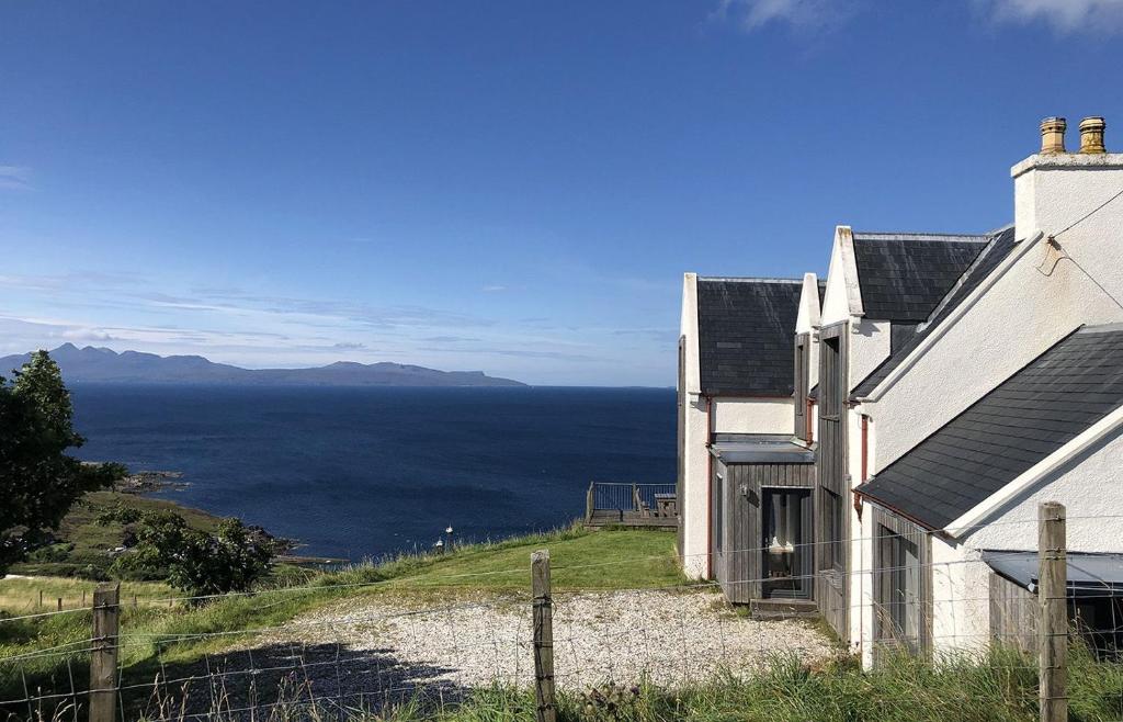 a house on a hill with a view of the ocean at Taigh Druim in Elgol
